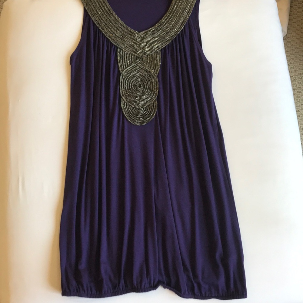 Purple sleeveless blouse with beautiful embellishm